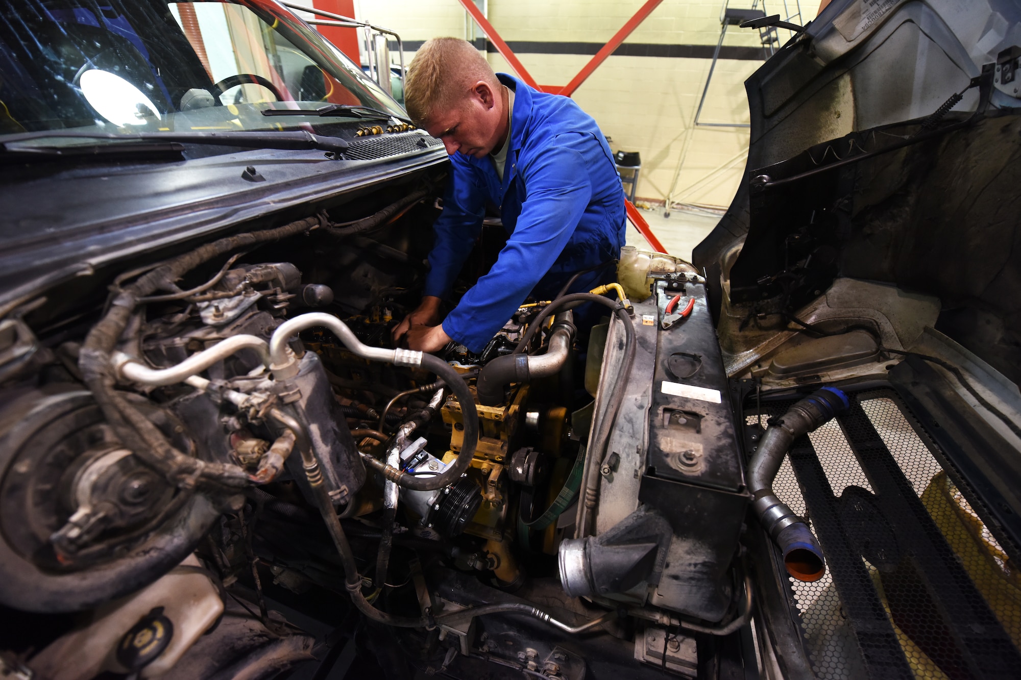 Senior Airman Jason Brown, 341st Logistics Readiness Squadron truck and tractor shop vehicle mechanic, works on a maintenance van engine July 27, 2015, at Malmstrom Air Force Base, Mont. The 341st LRS truck and tractor maintenance shop maintains all semi trucks and trailers on base. (U.S. Air Force photo/Chris Willis)