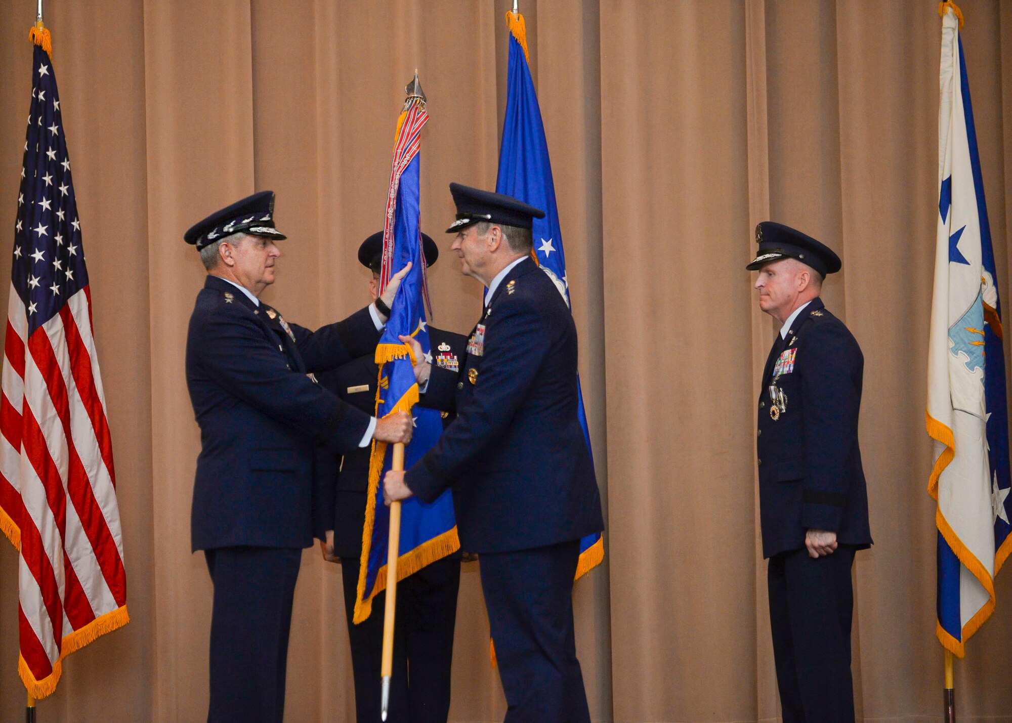 Gen. Robin Rand accepts the Air Force Global Strike Command flag from Air Force Chief of Staff Gen. Mark A. Welsh III during a change of command ceremony at Barksdale Air Force Base, La., July 28, 2015. The Air Force elevated AFGSC to a four-star major command to provide its nuclear deterrence and global strike missions with the highest level of leadership oversight similar to the service’s other core operational missions. AFGSC develops and provides combat ready forces for safe, secure, and effective nuclear deterrence and conventional global strike operations to support the President of the United States and combatant commanders. (U.S. Air Force photo/Senior Airman Jannelle Dickey)