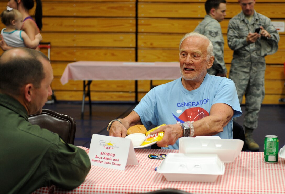 Buzz Aldrin, a former astronaut, and Col. Gentry Boswell, 28th Bomb Wing commander, eat lunch at the annual base picnic at Ellsworth Air Force Base, S.D., July 10, 2015. Aldrin's tour of Ellsworth was one stop, of many during his trip to South Dakota. (U.S. Air Force photo by Airman 1st Class Denise M. Nevins/Released)