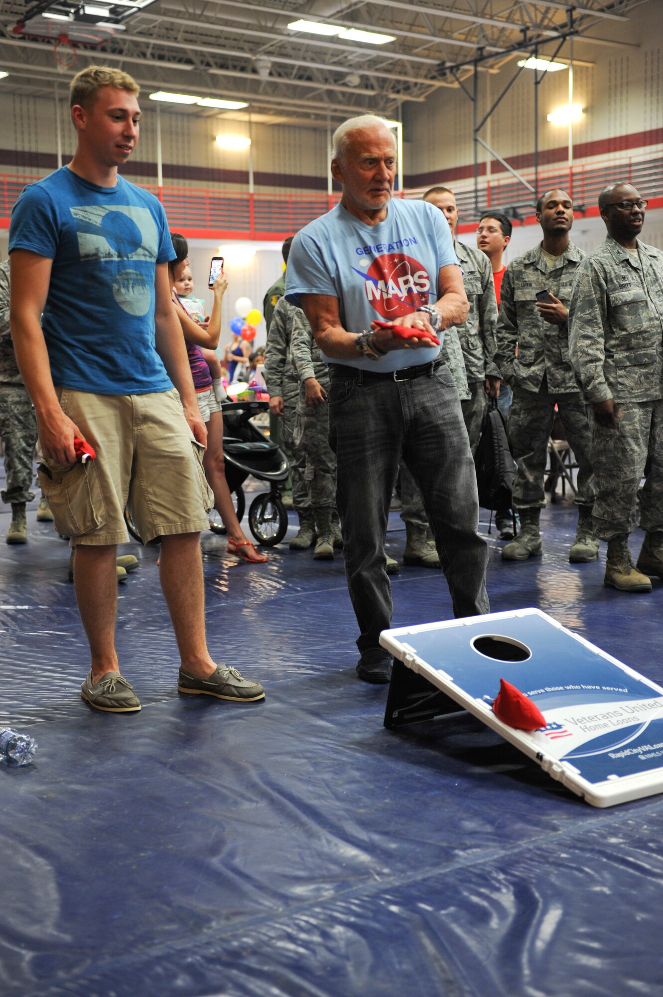 Buzz Aldrin, a former astronaut, plays a game of bean-bag toss while visiting the annual base picnic at Ellsworth Air Force Base, S.D., July 10, 2015. Aldrin, a former U.S. Air Force officer and command pilot, met with base leadership and toured the base with Senator John Thurne during his visit to South Dakota. (U.S. Air Force photo by Airman 1st Class Denise M. Nevins/Released)