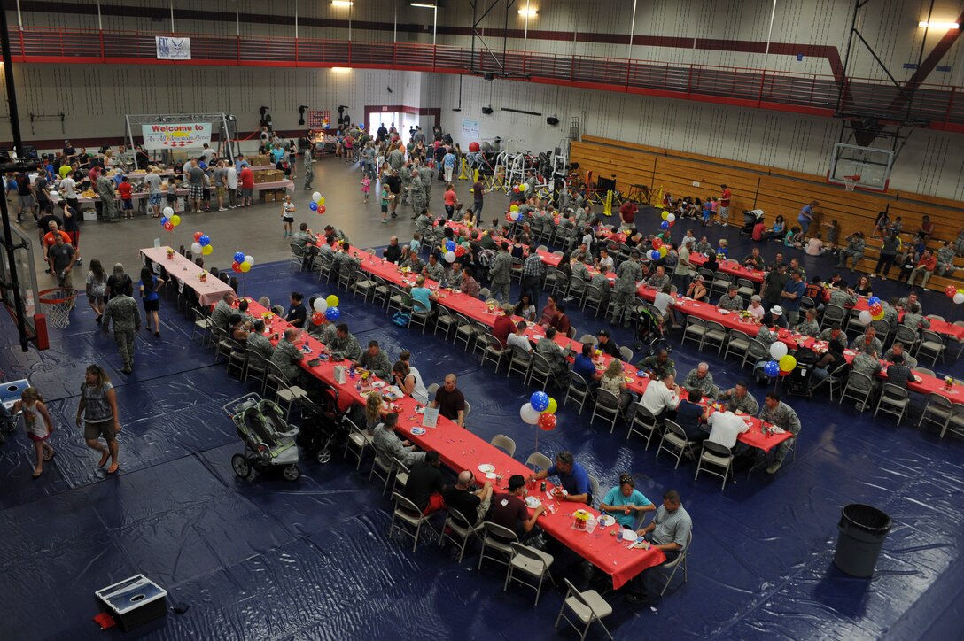 Airmen and families take part in the annual base picnic at Ellsworth Air Force Base, S.D., July 10, 2015. The event included free food, such as hamburgers, hot dogs, and coleslaw, as well as entertainment for children and adults. (U.S. Air Force photo by Airman 1st Class Denise M. Nevins/Released)
