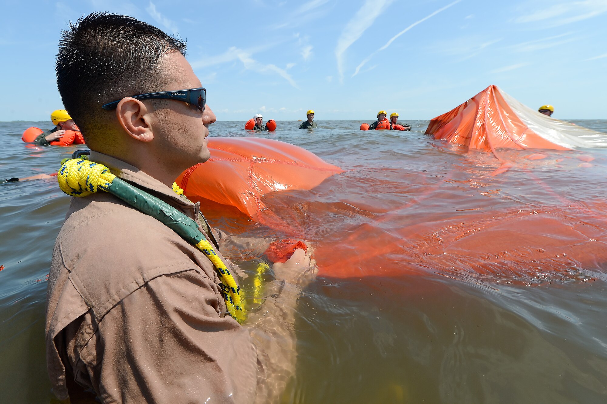 Technical Sgt. Joseph Monreal, 436th Operations Support Squadron Survival, Evasion, Resistance and Escape Operations flight chief, watches as a trainee uses a seam in a C-9 round parachute canopy to move from one edge to the other during aircrew water survival refresher training in the Delaware Bay July 17, 2015, near Dover Air Force Base, Del. Aircrew members of the 436th Airlift Wing, 512th Airlift Wing which operate the C-5M Super Galaxy and C-17A Globemaster III, participated in the required refresher training. (U.S. Air Force photo/Greg L. Davis)