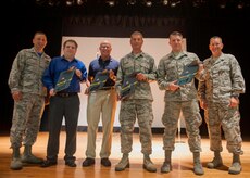Col. John Lamontagne, 437th Airlift Wing commander (left) and Chief Master Sergeant Jeffrey Wilson, 437th AW acting command chief (right), congratulate the award winners of the 437th AW 2nd Quarterly Awards July 24, 2015, at Joint Base Charleston – Air Base, S.C. The quarterly awards are held to recognize outstanding Airmen, non-commissioned officers, senior non-commissioned officers, company grade officers and civilians for their hard work and dedication. The winners shown are (left to right) Civilian Category I, Eugene Livingston from the 437th Aerial Port Squadron; Civilian Category II, Joseph Cuthrell, from the 437th Operations Support Squadron; Master Sergeant Harold Gary (accepting on behalf of Staff Sgt. Bryce Whittington, 437th Aircraft Maintenance Squadron) as NCO of the Quarter; and Airman of the Quarter, Senior Airman Matthew Jones, from the 437th AMXS. Not pictured are Master Sgt. Duriel Jackson, 437th AMXS, Senior Non-Commissioned Officer in Charge of the Quarter; and 1st Lt. David Loska, 437th AMXS, who is the Company Grade Officer of the Quarter. (U.S. Air Force photo/Staff Sgt. William O’Brien)