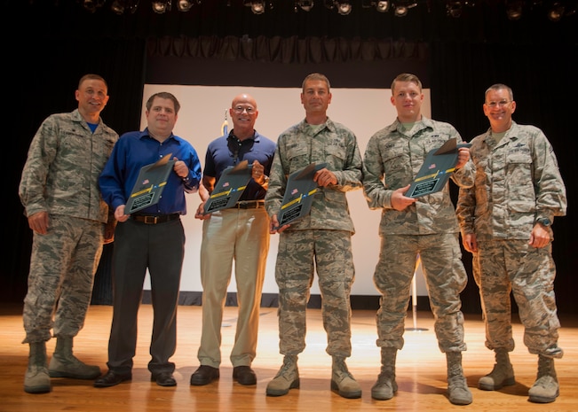 Col. John Lamontagne, 437th Airlift Wing commander (left) and Chief Master Sergeant Jeffrey Wilson, 437th AW command chief (right), congratulate the award winners of the 437th AW 2nd Quarterly Awards July 24, 2015, at Joint Base Charleston – Air Base, S.C. The Quarterly Awards are held to recognize outstanding Airmen, non-commissioned officers, senior non-commissioned officers, company grade officers and civilians for their hard work and dedication. The winners shown are (left to right) Civilian Category I, Eugene Livingston from the 437th Aerial Port Squadron, Civilian Category II, Joseph Cuthrell, Master Sergeant Harold Gary (accepting on behalf of Staff Sgt. Bryce Whittington) and, Airman of the Quarter, Senior Airman Matthew Jones. Not pictured are Senior Non-Commissioned Officer in Charge of the Quarter, Master Sergeant Duriel Jackson and the Command Grade Officer of the Quarter, 1st Lt. David Loska.  (U.S. Air Force photo/Staff Sgt. William O’Brien)
