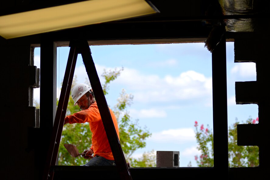 A civilian contractor prepares an opening on the 20th Component Maintenance Squadron building for a window at Shaw Air Force Base, S.C., July 18, 2015. The building has been under construction for the past few months, receiving several upgrades including a new roof and windows. (U.S. Air Force photo by Senior Airman Jensen Stidham/Released)
