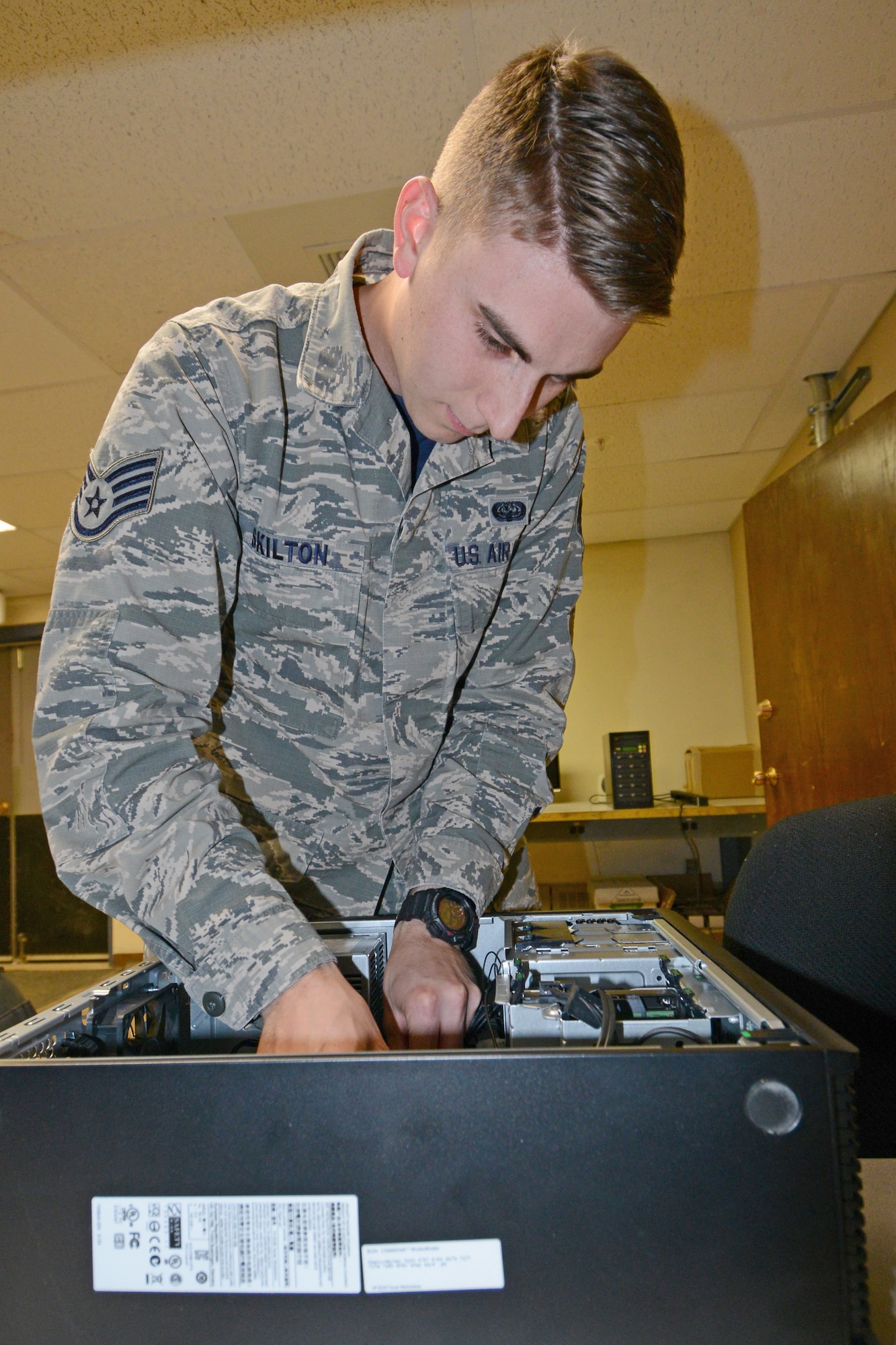 U.S. Air Force Staff Sgt. Jeremiah Skilton, the 354th Communications Squadron NCO in-charge of client systems, resets a computer’s random access memory July 24, 2015, at Eielson Air Force Base, Alaska. Skilton said his favorite part of the job is being a supervisor to six Airmen. (U.S. Air Force photo by Senior Airman Ashley Nicole Taylor/Released)