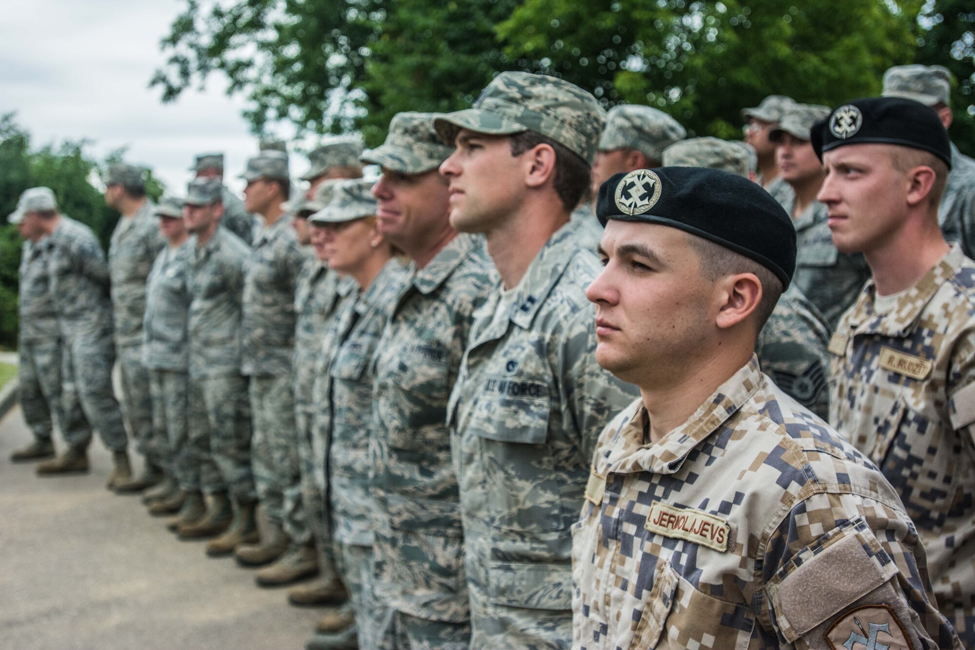 U.S. Airmen with the 139th Civil Engineer Squadron, Missouri Air National Guard, and soldiers with the Latvian National Armed Forces attend the ribbon-cutting ceremony at a newly reconstructed building of the Naujenu Orphanage near Daugavpils, Latvia, July 23, 2015.  The 139th CE was participating in the Humanitarian Civic Assistance project through the United States European Command, that pairs units training requirements with humanitarian needs.   (U.S. Air Force photo by Senior Airman Patrick P. Evenson/Released)