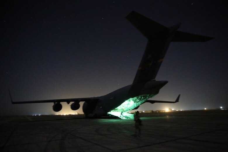 U.S. Airmen with the 321st Contingency Response Element prepare to offload a C-17 Globemaster at Al Taqaddum Air Base, Iraq, July 1, 2015. The 321st brings with it all the necessary elements for expeditionary airfield operations such as air traffic control, aerial porters and security forces who were instrumental in helping the Special Purpose Marine Air-Ground Task Force-Crisis Response-Central Command with the establishment of Task Force Al Taqaddum. (U.S. Marine Corps photo by Cpl. John Baker / RELEASED)