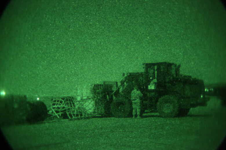 U.S. Airmen with 321st Contingency Response Element move cargo with a 10k forklift on the airfield during the initial establishment of Al Taqaddum Air Base, Iraq, July 1, 2015. Airmen of the 321st work primarily at night, using night vision goggles to navigate around the airfield and perform a full range of expeditionary air operation capabilities. (U.S. Marine Corps photo by Cpl. John Baker / RELEASED)