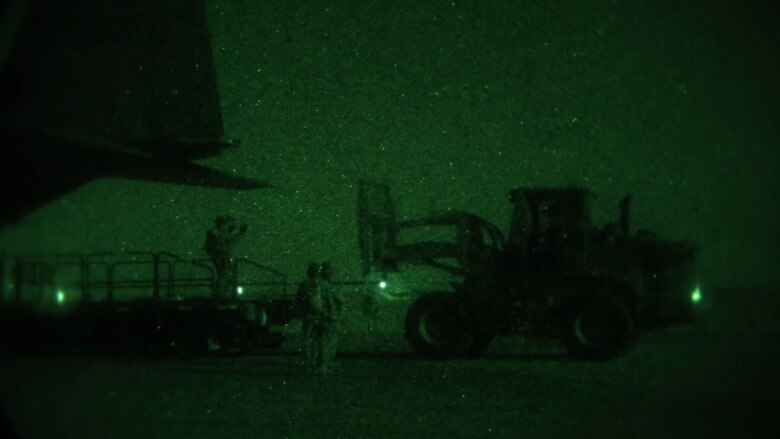 Airmen with 321st Contingency Response Element move cargo with a 10k forklift during the establishment of Al Taqaddum Air Base, Iraq, July 1, 2015. Airmen of the 321st work primarily at night, using night vision goggles to navigate around the airfield and perform a full range of expeditionary air operation capabilities. (U.S. Marine Corps photo by Cpl. John Baker / RELEASED)