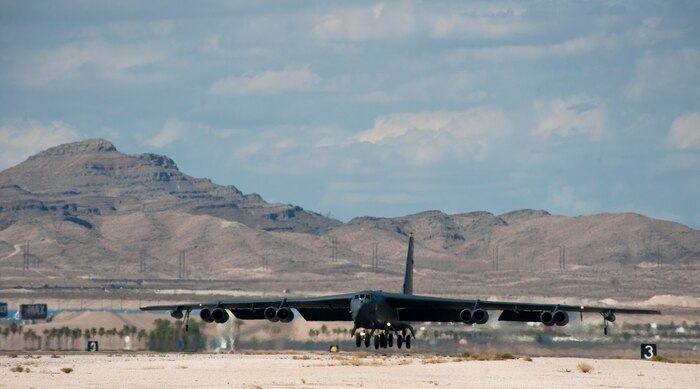 A B-52 Stratofortress assigned to the 69th Bomb Squadron, Minot Air Force Base, N.D., lands during Red Flag 15-3 at Nellis AFB, Nev., July 21, 2015. The B-52 is a long-range, heavy bomber that is capable of flying at high subsonic speeds, at altitudes up to 50,000 feet, and can carry up to 70,000 pounds of weapons including nuclear or guided conventional ordnance with worldwide precision navigation capability. (U.S. Air Force photo by Senior Airman Thomas Spangler)