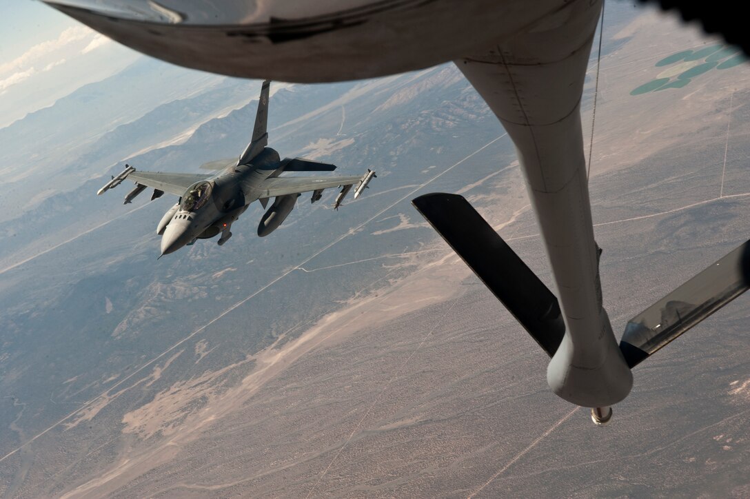 An F-16 Fighting Falcon from the 422nd Test and Evaluation Squadron, Nellis Air Force Base, Nev., maneuvers into position to refuel off the tail of a KC-135 Stratotanker assigned to the 344th Air Refueling Squadron, McConnell Air Force Base, Kan., during a Red Flag 15-3 training sortie over the Nevada Test and Training Range, July 24, 2015. Aerial refueling extends an aircraft’s mission longevity, allowing strike packages to reach great distances in pursuing targets and enabling them to stay in the fight when needed. (U.S. Air Force photo by Senior Airman Joshua Kleinholz)