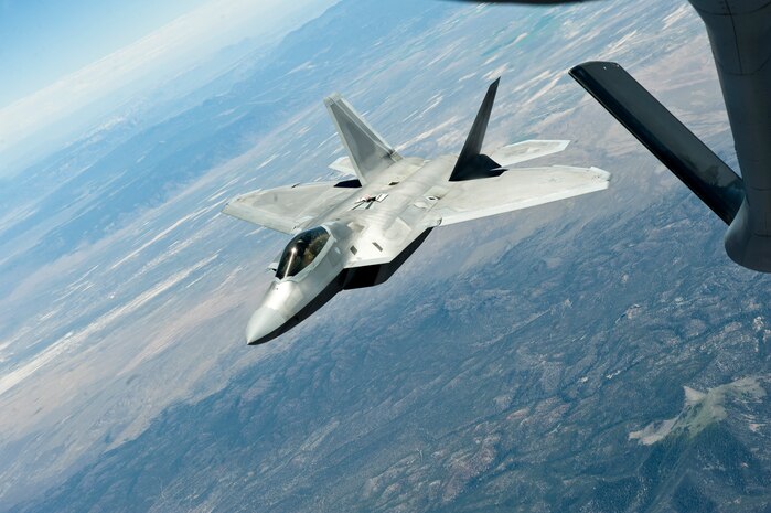 An F-22 Raptor from the 325th Fighter Squadron, Tyndall Air Force Base, Fla.,  banks and departs after refueling off the tail of a KC-135 Stratotanker assigned to the 344th Air Refueling Squadron, McConnell Air Force Base, Kan., during a Red Flag 15-3 training sortie over the Nevada Test and Training Range, July 24, 2015. This year marks the 40th anniversary of the Red Flag exercise, during which units from around the U.S. and allied militaries integrate capabilities fighting through complex air, space, and cyber warfare training scenarios. (U.S. Air Force photo by Senior Airman Joshua Kleinholz)