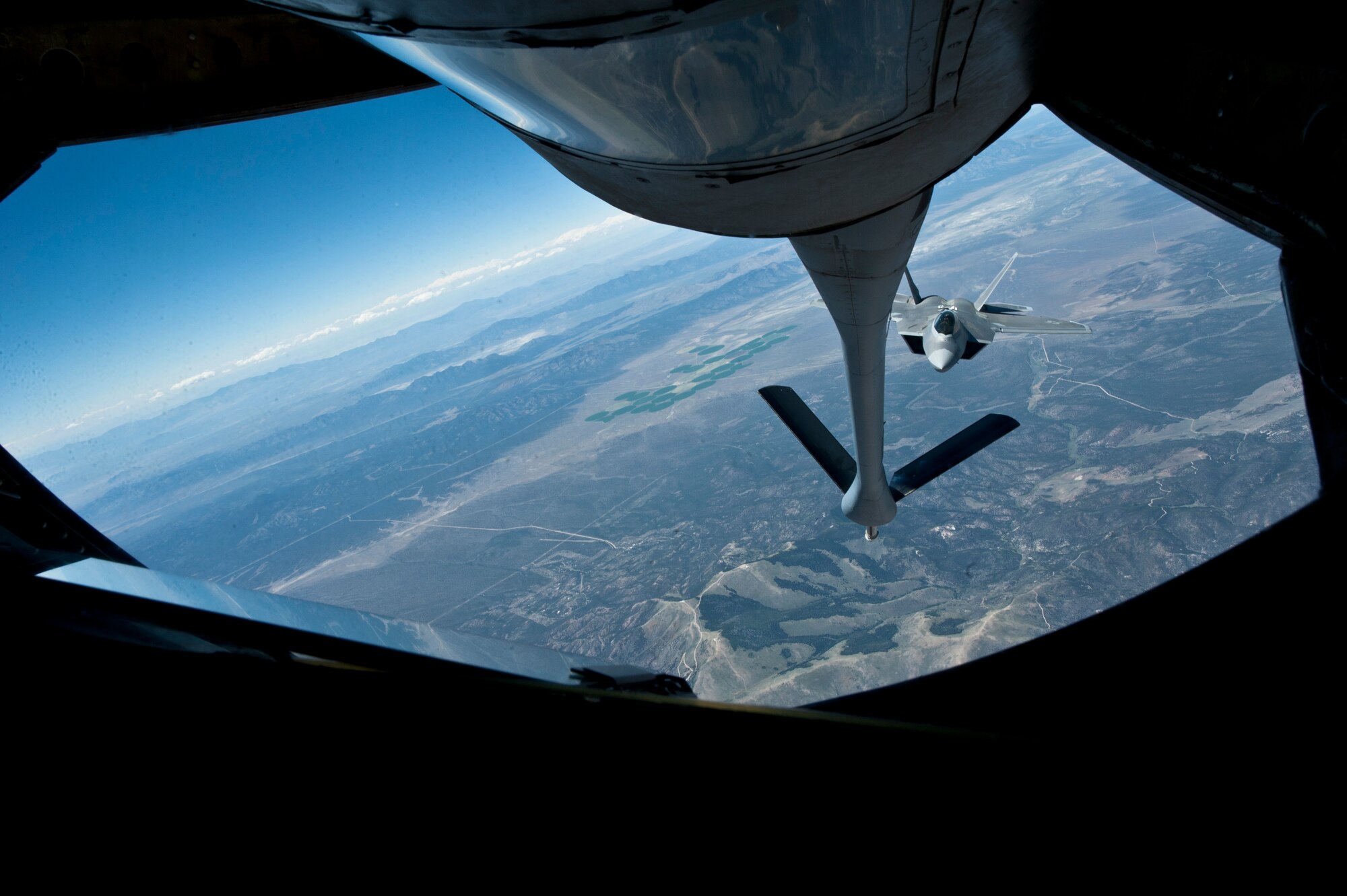 An F-22 Raptor assigned to the 325th Fighter Squadron, Tyndall Air Force Base, Fla.,  makes an approach to refuel off the tail of a KC-135 Stratotanker assigned to the 344th Air Refueling Squadron, McConnell Air Force Base, Kan., during a Red Flag 15-3 training sortie over the Nevada Test and Training Range, July 24, 2015. The F-22 is an air dominance, multi-role fighter aircraft suited for both air-to-air and air-to-ground missions, allowing full realization of operational concepts vital to the 21st century Air Force. (U.S. Air Force photo by Senior Airman Joshua Kleinholz)
