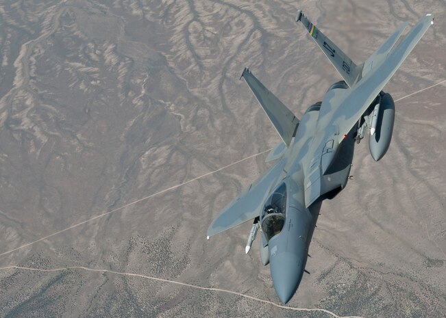 An F-15C assigned to the 122nd Fighter Squadron, Louisiana Air National Guard, banks after refueling from a KC-135 Stratotanker during a Red Flag 15-3 training mission over the Nevada Test and Training Range, July 24, 2015. Different units from across the Department of Defense and allied nations come to Red Flag to train in intense air-to-air combat scenarios which will prepare them for future real-world operations. (U.S. Air Force photo by Airman 1st Class Jake Carter)