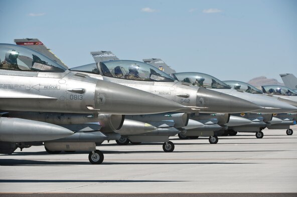 Pilots from Shaw Air Force Base, S.C., and Spangdalam Air Base, Germany wait for take off while pre-flight checks are performed on their aircraft on the flightline at Nellis Air Force Base, Nev., July 23, 2015. Units from around the world came to experience and participate in the best training they can receive in the air, space and cyberspace realm of operations. (U.S. Air Force photo by Airman 1st Class Jake Carter)
