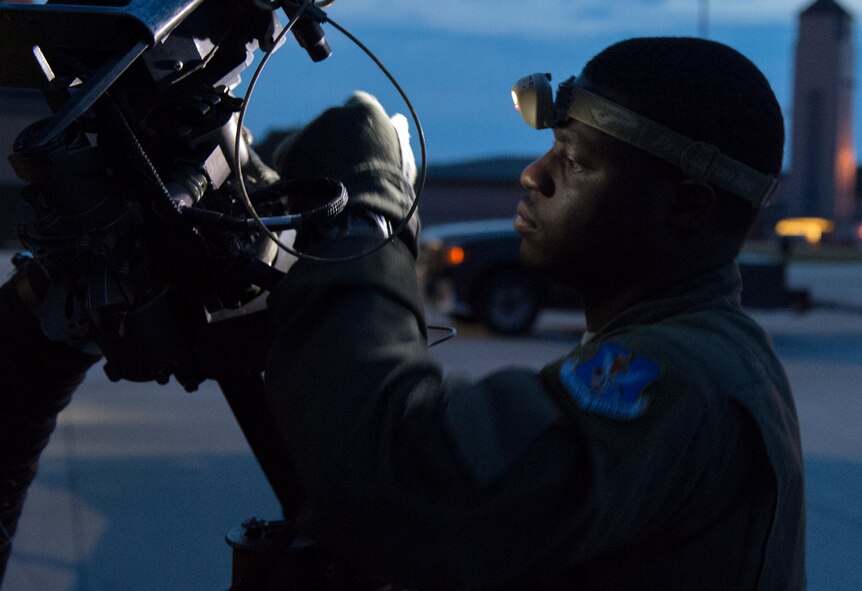 Tech. Sgt. Uwemediimo Essien, 41stt Rescue Squadron special missions aviator, inspects a GAU-2/A 7.62 mm minigun during preflight checks July 21, 2015, at Moody Air Force Base, Ga. This was Essien’s first base as a special mission aviator, where he spent three and a half years, and will be heading to Kirtland AFB, N.M., where he will become an instructor. (U.S. Air Force photo/Tech. Sgt. Zachary Wolf/Released)