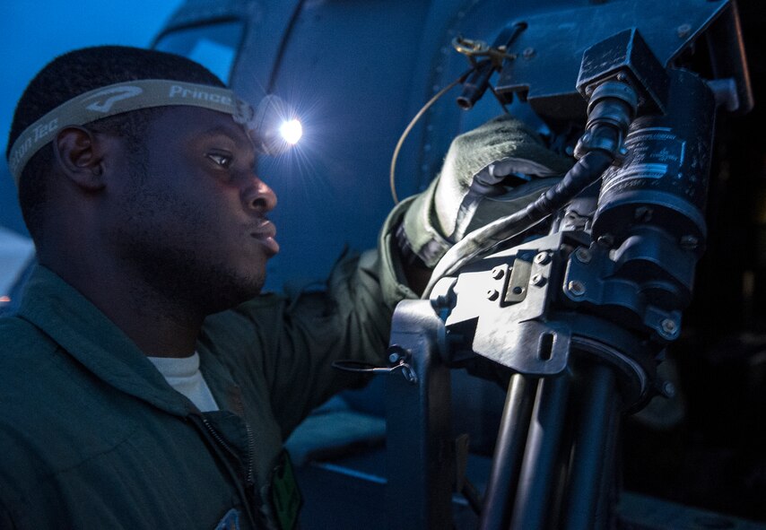 Tech. Sgt. Uwemediimo Essien, 41st Rescue Squadron special missions aviator, inspects a GAU-2/A 7.62 mm minigun during preflight checks July 21, 2015, at Moody Air Force Base, Ga. After Basic Aerial Gunner School, Essien went to Fairchild AFB, Wash., for Survival, Evasion, Resistance and Escape school that all aircrew and battlefield airmen attend to learn how to survive on their own. (U.S. Air Force photo/Tech. Sgt. Zachary Wolf/Released)