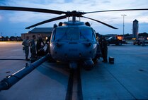 An HH-60G Pave Hawk rests on the flight line as 41stt Rescue Squadron special missions aviators perform preflight inspections July 21, 2015, on Moody Air Force Base, Ga. Tech. Sgt. Uwemediimo Essien, 41st RQS special missions aviator, said he had trouble with the water survival portion of his training, but spent his time and money practicing treading water at the base pool and went back and passed that portion. (U.S. Air Force photo/Tech. Sgt. Zachary Wolf/Released)
