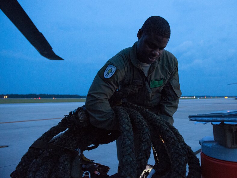 Tech. Sgt. Uwemediimo Essien, 41st Rescue Squadron special missions aviator, prepares to load an HH-60G Pave Hawk during pre-flight checks July 21, 2015, on Moody Air Force Base, Ga. After attaining his U.S. citizenship, Essien applied three times to become an aerial gunner before it merged with flight engineers and became the special missions aviation career field. (U.S. Air Force photo/Tech. Sgt. Zachary Wolf/Released)