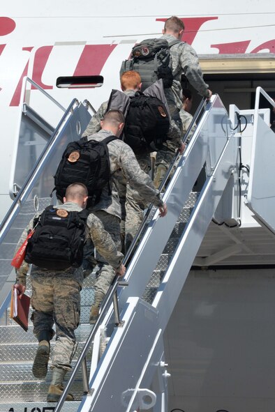 Airmen board an aircraft at Ellsworth Air Force Base, S.D., July 24, 2015, in preparation for a deployment to Southwest Asia. Airmen in a variety of non-aviation roles will perform a wide range of sortie generation and mission assurance duties. (U.S. Air Force photo by Senior Airman Rebecca Imwalle/Released)