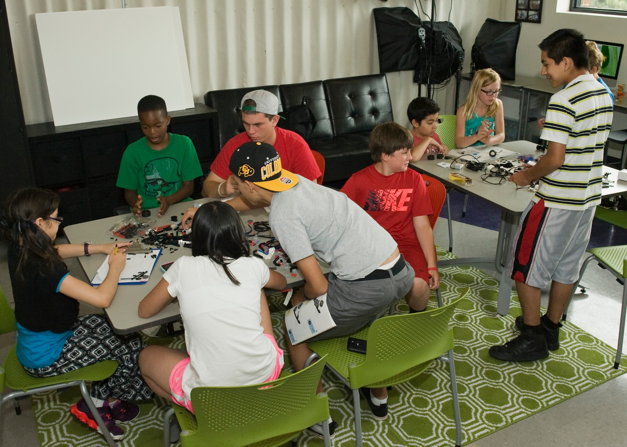 PETERSON AIR FORCE BASE, Colo. – Kids build a robot after learning about robotics during the STEM Camp held at the R.P. Lee Youth Center, July 21, 2015. The Science, Technology, Engineering and Mathematics subjects were the base of everything taught throughout the week long camp, in which kids learned new material and then used their hands to build projects based upon their new knowledge. (U.S. Air Force photo by Airman 1st Class Rose Gudex)