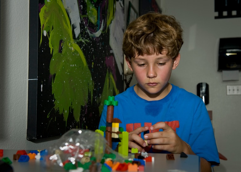 PETERSON AIR FORCE BASE, Colo. – Shelton Krasinski, 10, uses newly acquired engineering knowledge to build a working swing out of Legos during a STEM camp at the R.P. Lee Youth Center, July 21, 2015. This is the first year the Science, Technology, Engineering and Mathematics Camp was offered, which was designed for kids to get a chance to learn about STEM as use their hands to build a project based off what was learned. The camp was from July 20-24. (U.S. Air Force photo by Airman 1st Class Rose Gudex)