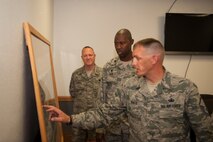 Members of the 5th Logistics Readiness Squadron show Lt. Col. Jamaal Mays, 5th LRS commander, a map of Minot Air Force Base, N.D., with fuel pipelines highlighted for current and future projects ,July 21, 2015. Mays said the new pipeline is a “win” for the environment and team Minot. (U.S. Air Force photo/Airman 1st Class Christian Sullivan)