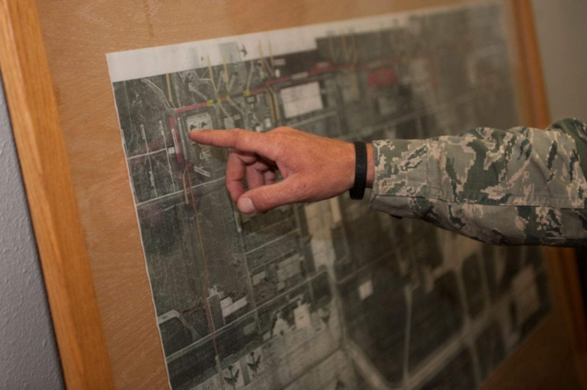 Members of the 5th Logistics Readiness Squadron show Lt. Col. Jamaal Mays, 5th LRS commander, a map of Minot Air Force Base, N.D., with fuel pipelines highlighted for current and future projects, July 21, 2015. Mays said the new pipeline is a “win” for the environment and team Minot. (U.S. Air Force photo/Airman 1st Class Christian Sullivan)