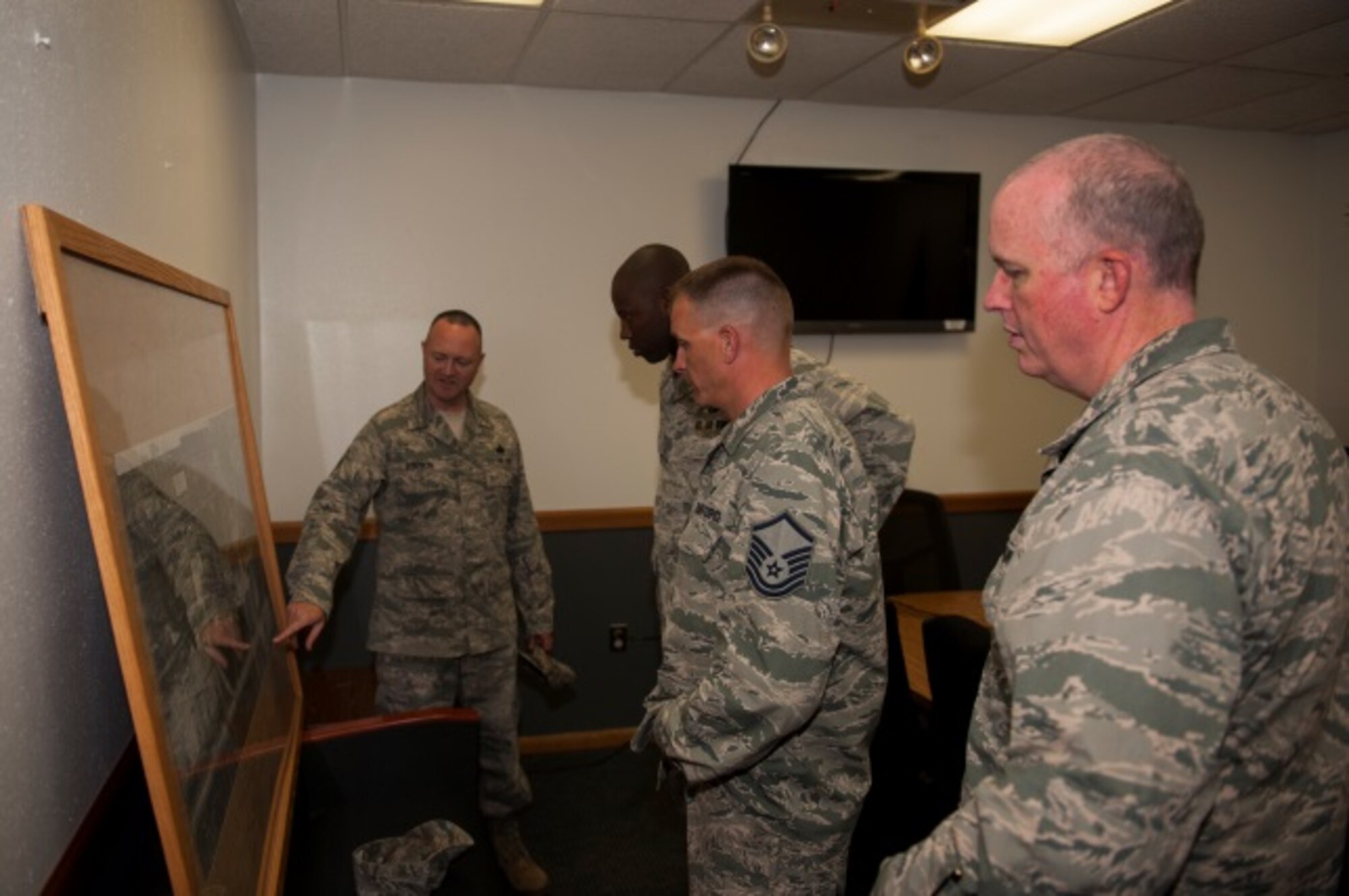 Members of the 5th Logistics Readiness Squadron show Lt. Col. Jamaal Mays, 5th LRS commander, a map of Minot Air Force Base, N.D., with fuel pipelines highlighted for current and future projects, July 21, 2015. Mays said the new pipeline is a “win” for the environment and team Minot. (U.S. Air Force photo/Airman 1st Class Christian Sullivan)