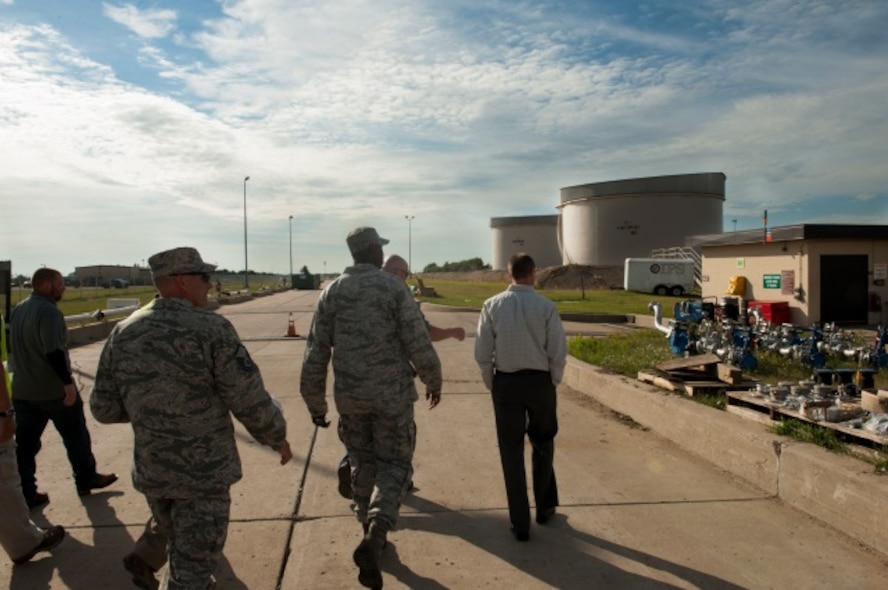 Members of Minot Air Force Base, N.D., and contractors observe fuel pumps, July 21, 2015. The new project ensures an environmentally safe future for any fuels pipeline transfers that resupplies the lifeblood of the 5th Bomb Wing mission, said Master Sgt. Clint Ericson, 5th Logistics Readiness Squadron fuels superintendent. (U.S. Air Force photo/Airman 1st Class Christian Sullivan)