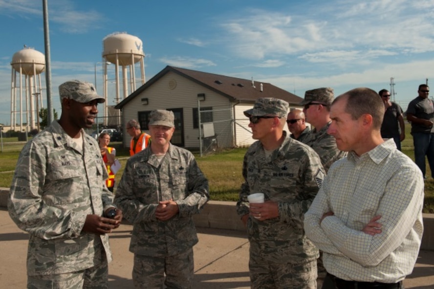 Lt. Col. Jamaal Mays, 5th Logistics Readiness Squadron commander, talks to members of Minot Air Force Base, N.D., and contractors who oversaw the new fuels pipeline project at the base, July 21, 2015. The new pipeline holds only 25,000 gallons of jet fuel compared to the 54,000 gallons before the renovation. (U.S. Air Force photo/Airman 1st Class Christian Sullivan)