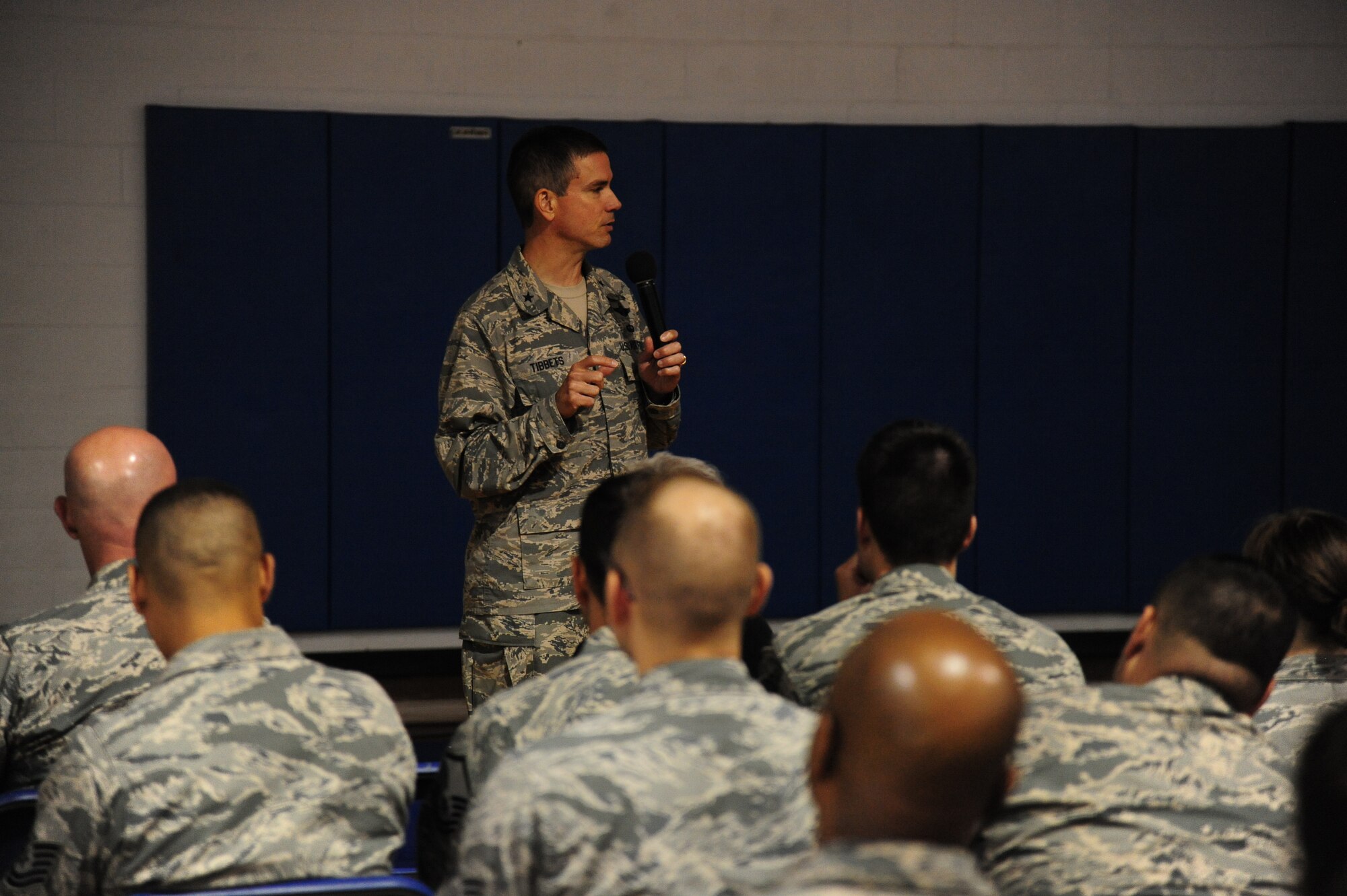 Brig. Gen. Paul W. Tibbets IV, 509th Bomb Wing commander, briefs Airmen during a commander’s call at Whiteman Air Force Base, Mo., July 21, 2015. Tibbets, who recently assumed command of the 509th BW, held a series of commander’s calls as well as a town hall meeting to discuss his top priorities and field questions from Airmen and their families. (U.S. Air Force photo by Senior Airman Joel Pfiester/Released)