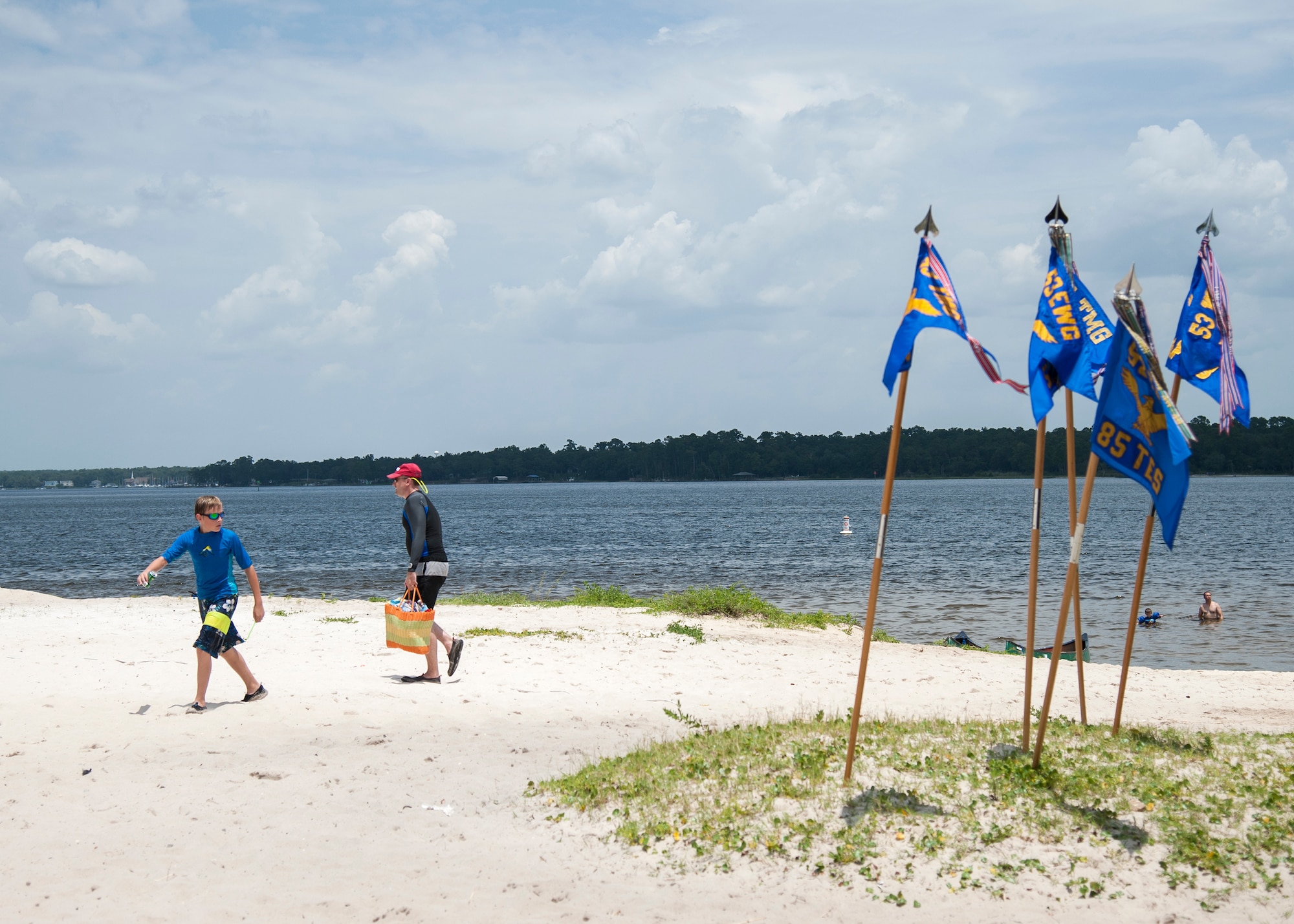 53rd Wing guidons fly during the wing’s annual picnic and sports day July 24 at Post’l Point on Eglin Air Force Base, Fla. The annual event featured several team sports, physical fitness challenges, a military working dog demonstration, music, lunch, kayak races and an awards ceremony. (U.S. Air Force photo/Ilka Cole)