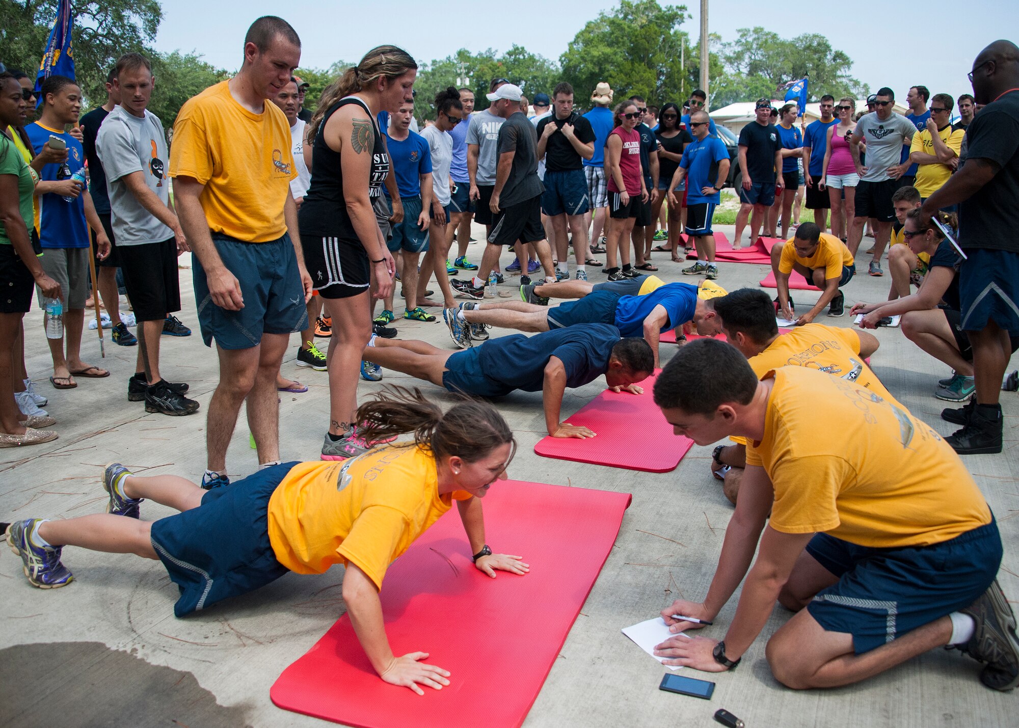 Members of the 53rd Wing compete in a push-up challenge during the wing’s annual picnic and sports day July 24 at Post’l Point on Eglin Air Force Base, Fla. The annual event featured several team sports, physical fitness challenges, a military working dog demonstration, music, lunch, kayak races and an awards ceremony. (U.S. Air Force photo/Ilka Cole)