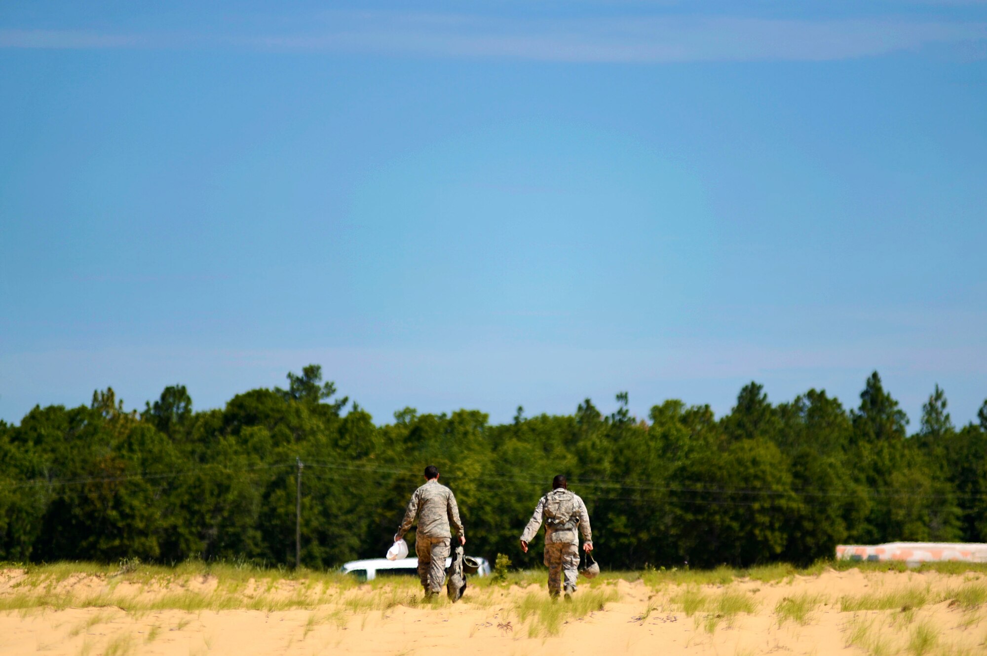 Members of the 20th Security Forces Squadron leave the firing range after weapons training at Poinsett Electronic Combat Range in Wedgefield, S.C., July 23, 2015. The 20th SFS and 20th Civil Engineer Squadron Airmen completed the weapons training, satisfying one of several pre-deployment requirements. (U.S. Air Force photo by Senior Airman Jensen Stidham/Released)