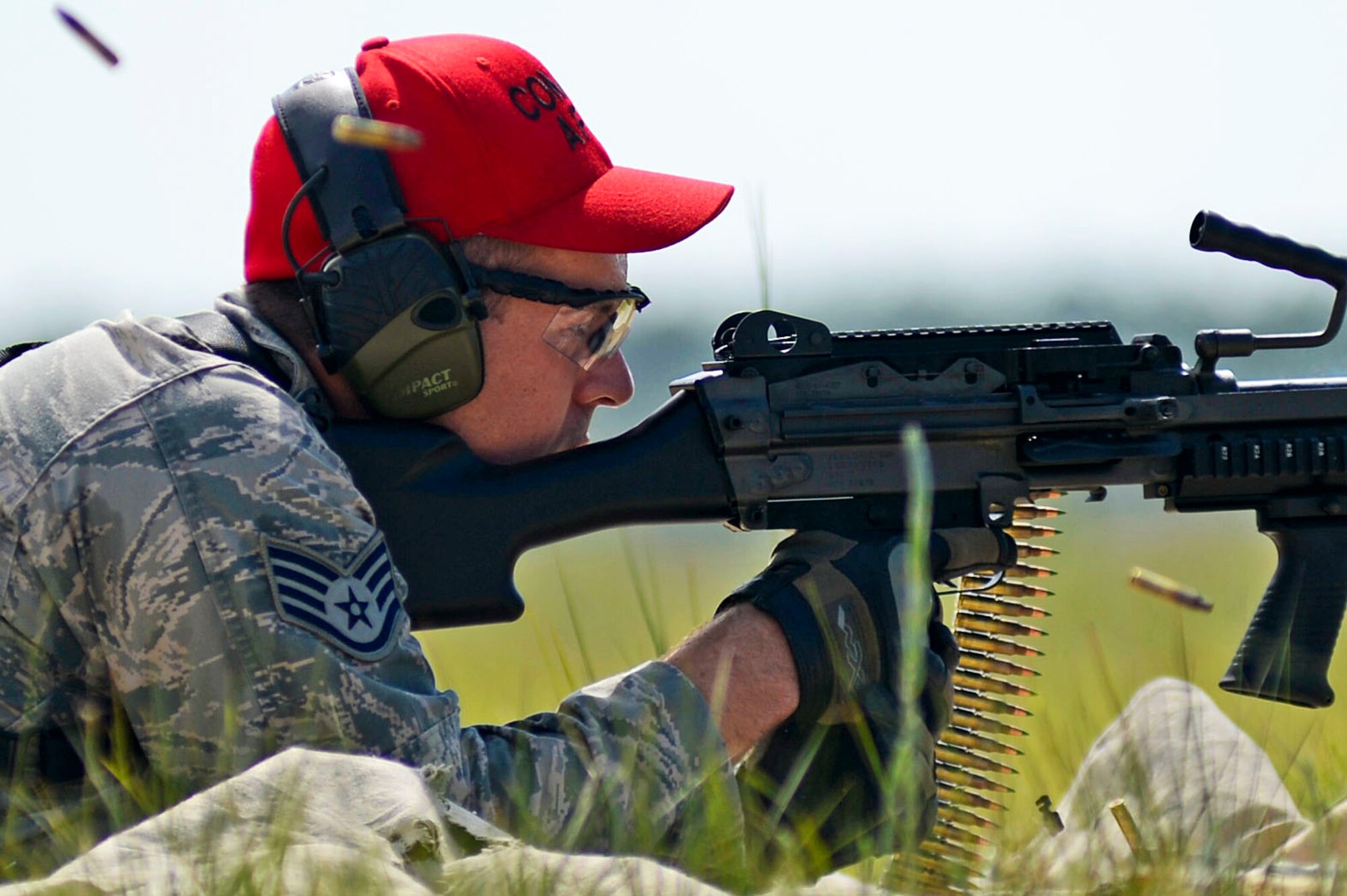 A combat arms instructor assigned to the 20th Security Forces Squadron, fires an M240 during weapons training at Poinsett Electronic Combat Range in Wedgefield, S.C., July 23, 2015. After the initial set up of each, the weapons are test fired by 20th SFS combat arms instructors to ensure they are firing correctly. (U.S. Air Force photo by Senior Airman Jensen Stidham/Released)