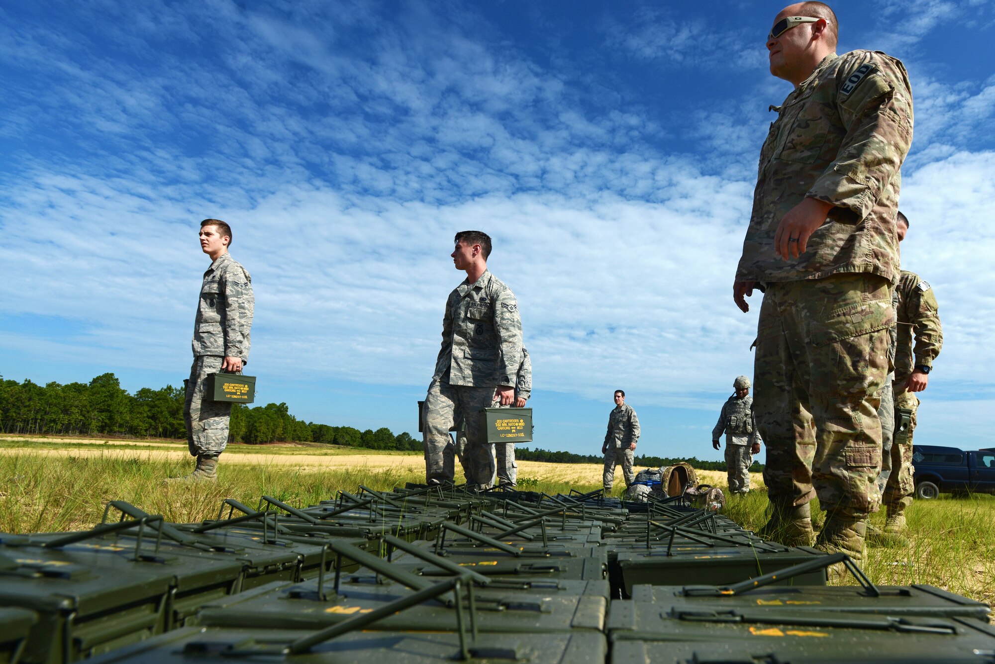 Airmen assigned to the 20th Security Forces Squadron and the 20th Civil Engineer Squadron line up ammunition during training at Poinsett Electronic Combat Range in Wedgefield, S.C., July 23, 2015. Each of the Airmen fired more than a thousand rounds during the training. (U.S. Air Force photo by Senior Airman Jensen Stidham/Released)