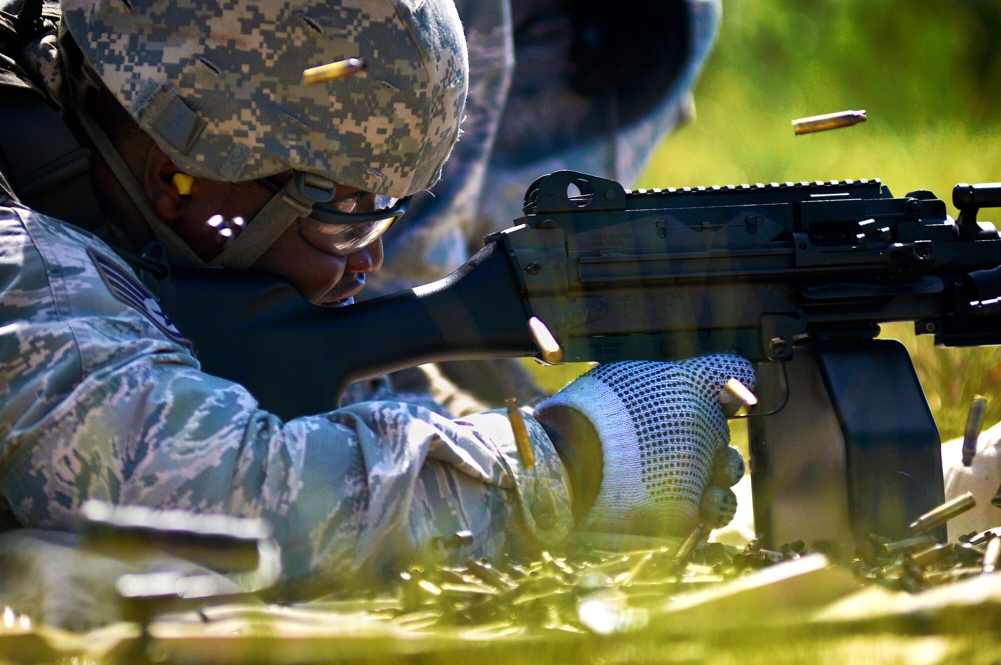 U.S. Air Force Staff Sgt. Jerel Nelson, 20th Security Forces Squadron patrolman, fires an M249, machine gun at Poinsett Electronic Combat Range in Wedgefield, S.C., July 23, 2015. The M249 is a lightweight machine gun that has been used in every major U.S. conflict since 1989. (U.S. Air Force photo by Senior Airman Jensen Stidham/Released)