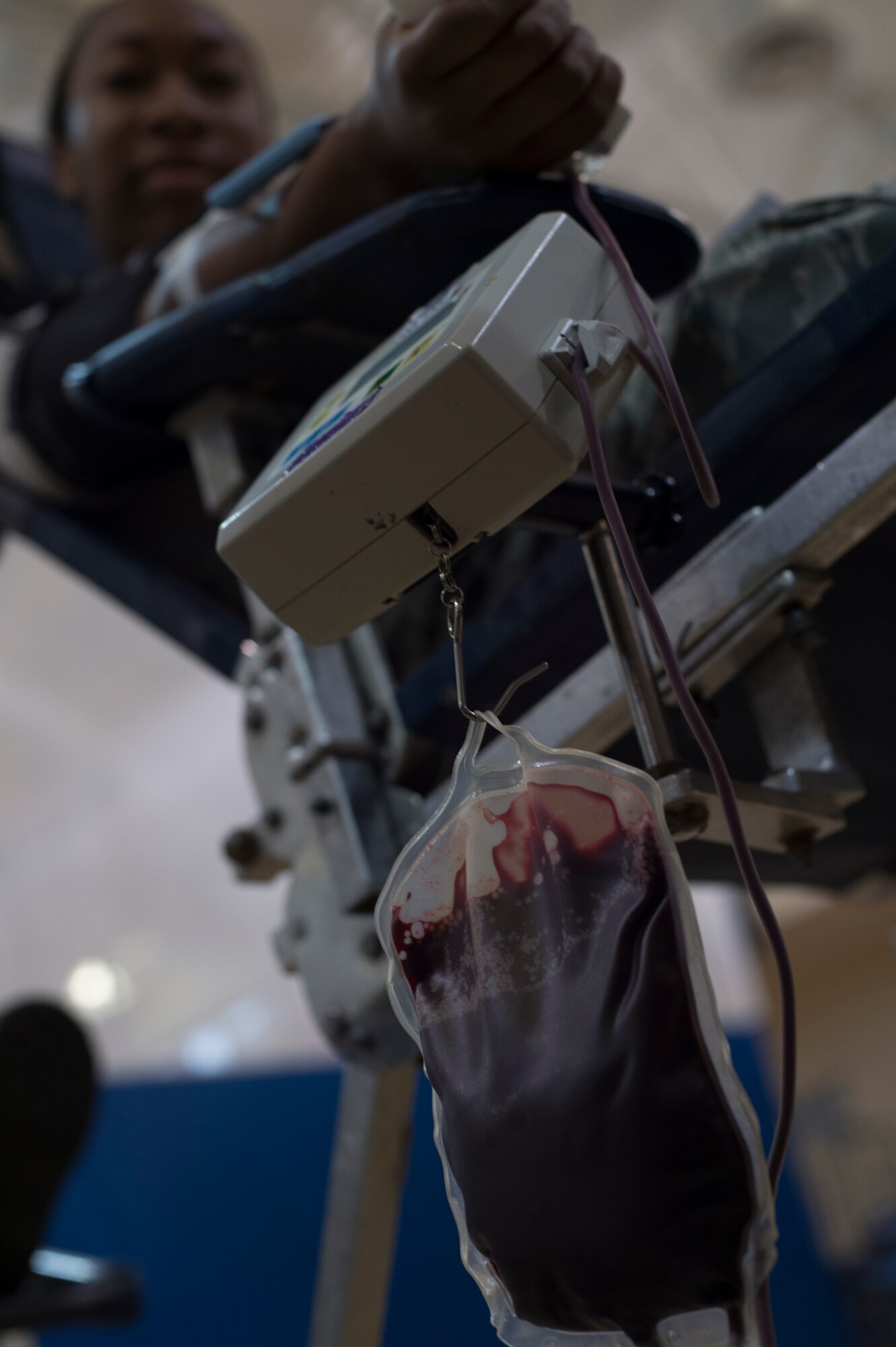 U.S. Air Force Airman 1st Class Miracle Strickland, 824th Base Defense Squadron, gives blood during a blood drive July 22, 2015, at Moody Air Force Base, Ga. The bag hangs from a scale that weighs the bag as it fills. When the bag is full, the machine beeps to let the technicians know it has reached the maximum weight. (U.S. Air Force photo by Staff Sgt. Eric Summers Jr./Released)