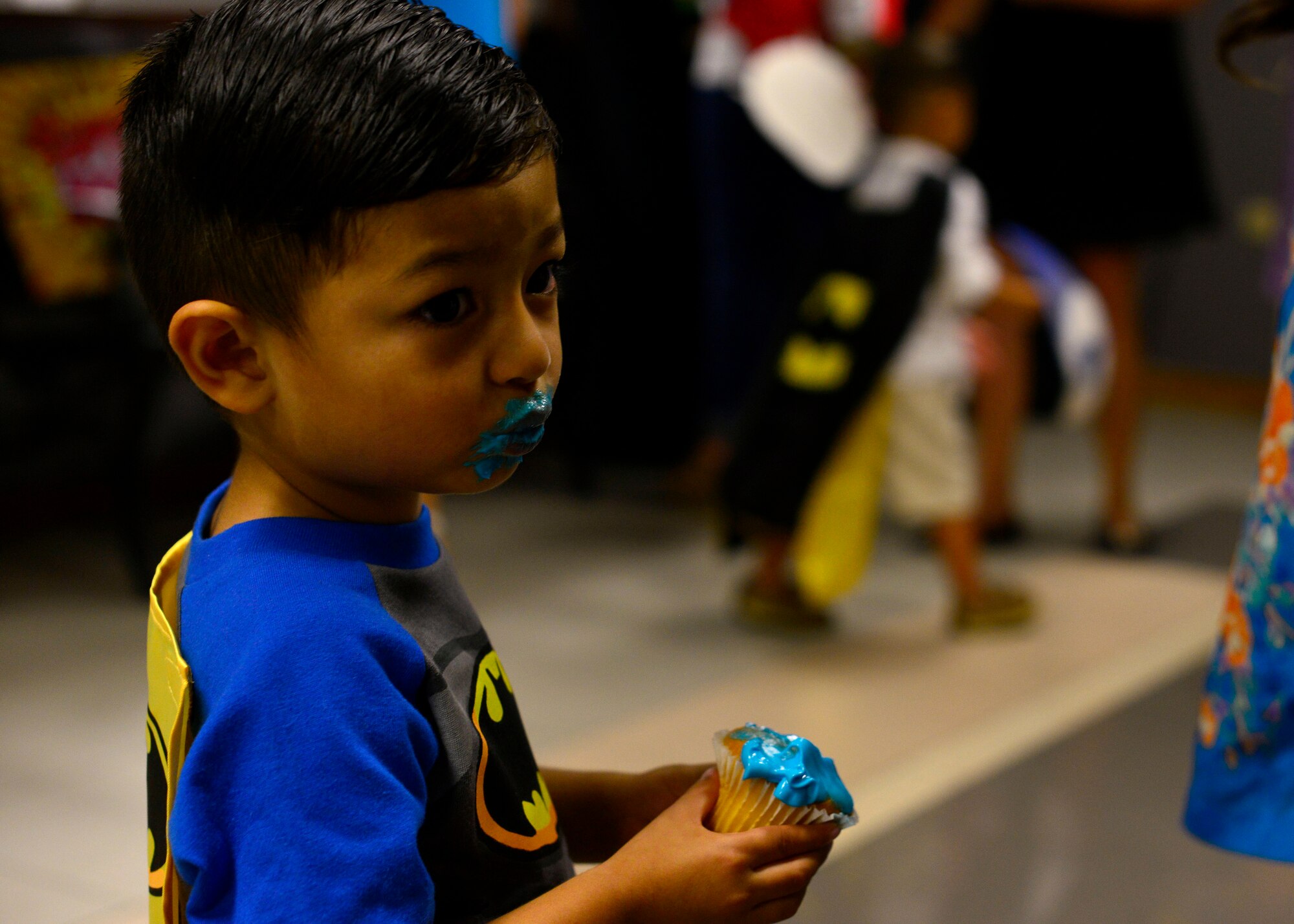 Eli Nguyen, son of Fara Nguyen, eats a cupcake during the first “Mother and Son dance,” July 25, 2015, at Aviano Air Base, Italy. The dance provided mothers and their sons the chance to enjoy a night of food and dancing. (U.S. Air Force photo by Airman 1st Class Cary Smith/Released)