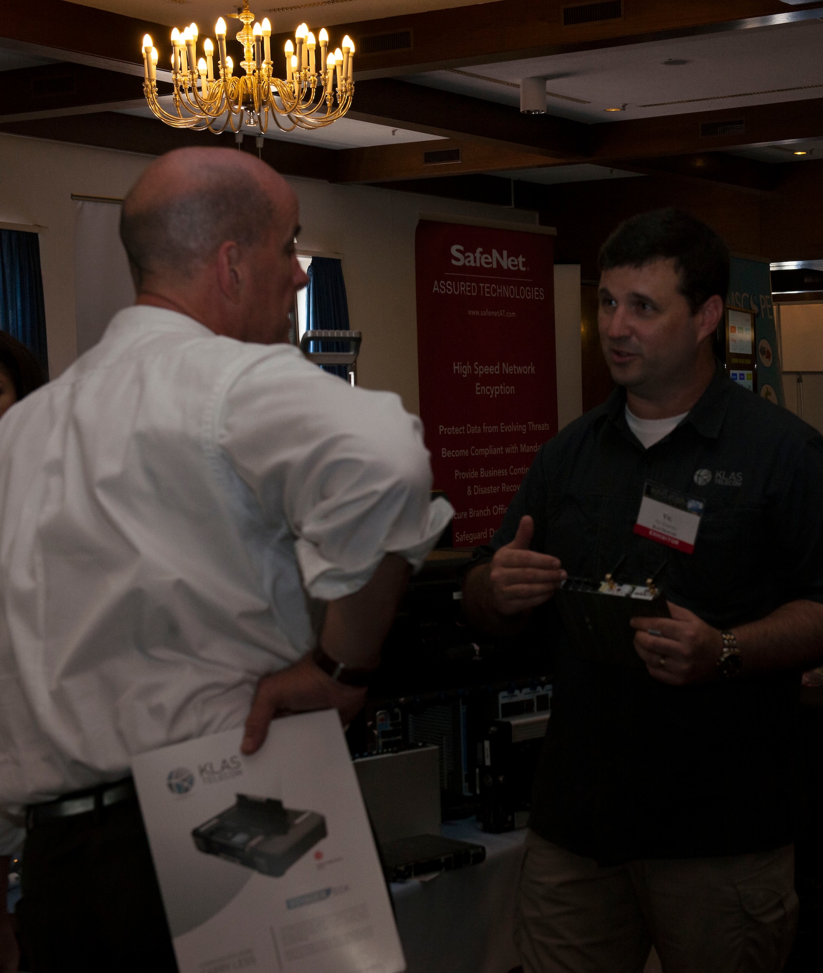 Victor Ferson, Klas Telecom director for business development, talks to a patron of the Armed Forces Communications-Electronics Association’s Technology Exposition July 21, 2015, at Ramstein Air Base, Germany. Over 65 companies participated in the two-day event to show the technologies available that may aid the military in completing their mission. (U.S. Air Force photo/Airman 1st Class Tryphena Mayhugh)