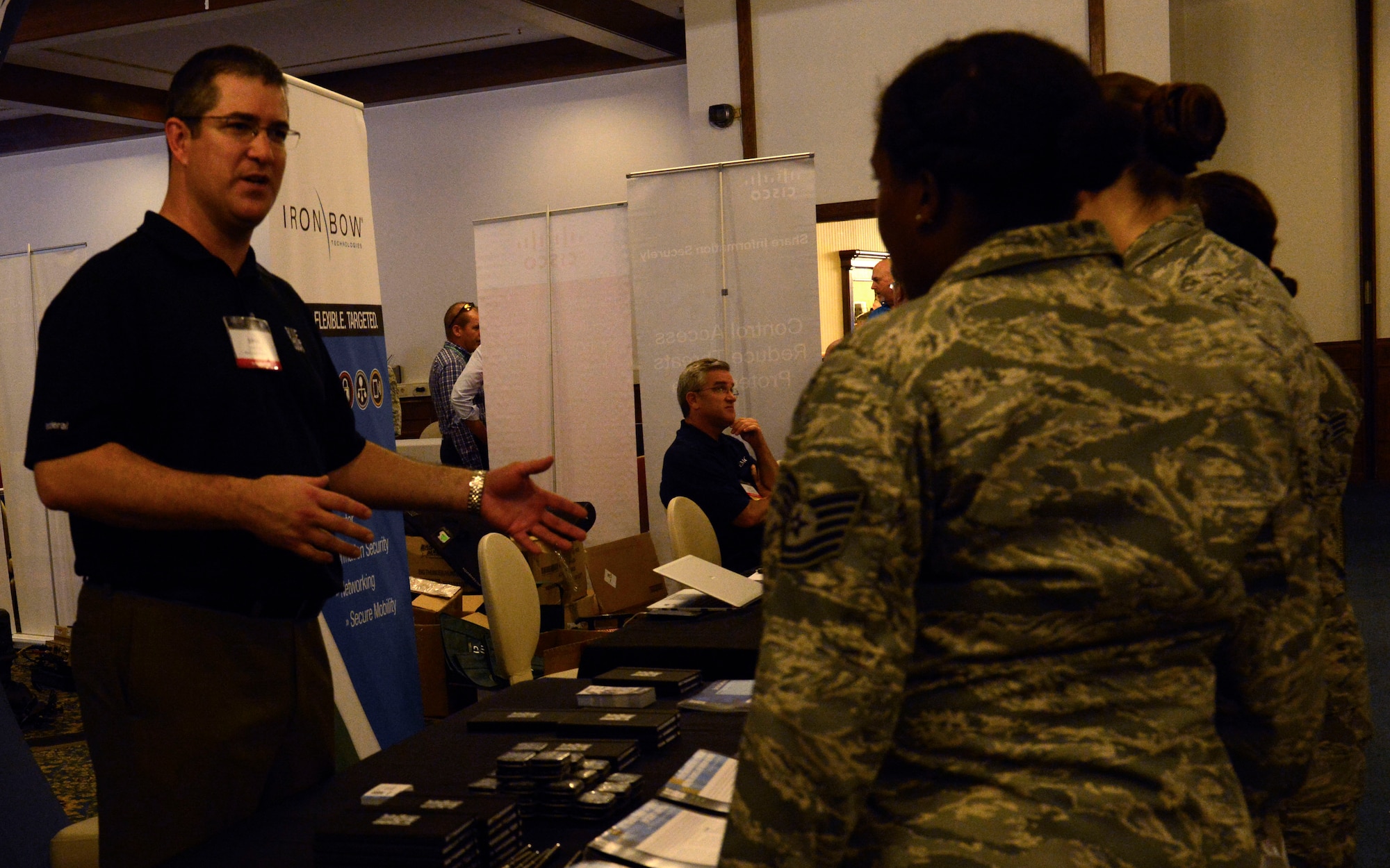 John A. Cox, Blue Coat senior federal systems engineer, talks to patrons of the Armed Forces Communications-Electronics Association’s Technology Exposition July 20, 2015, at Ramstein Air Base, Germany. Airmen and civilians alike were encouraged to attend the two-day expo to see what new technology is being offered by various companies. (U.S. Air Force photo/Airman 1st Class Tryphena Mayhugh)