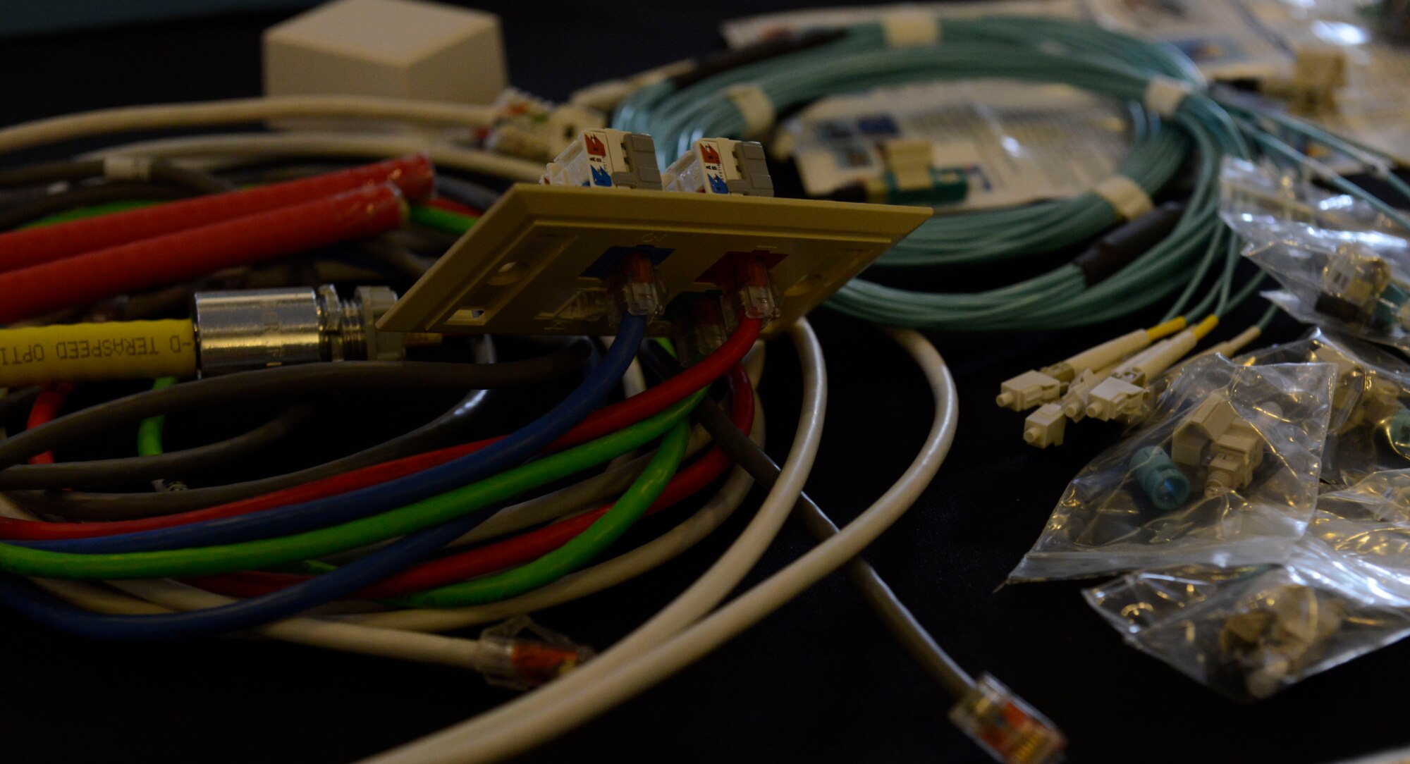 Cable wires and accessories lay on the AS Global Corporation booth at a technology exposition July 20, 2015, at Ramstein Air Base, Germany. The two-day expo, hosted by the Armed Forces Communications-Electronics Association, provided a venue for Airmen and civilians to see what new technology is available that may aid in completing their missions. (U.S. Air Force photo/Airman 1st Class Tryphena Mayhugh)