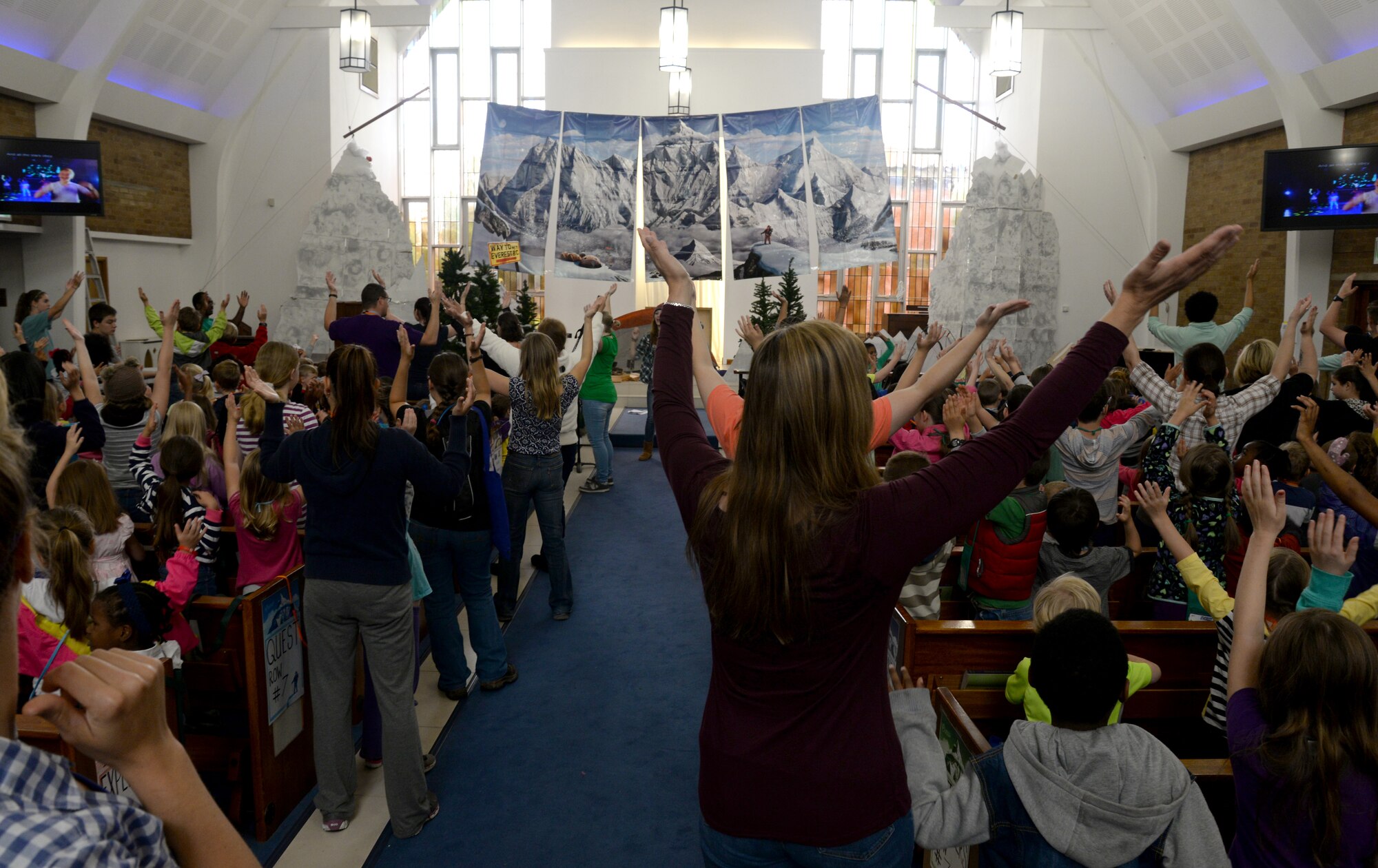 Team Mildenhall families sing songs to kick off this year’s vacation bible school July 27, 2015, at the Chapel on RAF Mildenhall, England. The week-long, “Everest” themed event hosted Team Mildenhall children from kindergarten to fifth grade. (U.S. Air Force photo by Senior Airman Kate Thornton/Released)