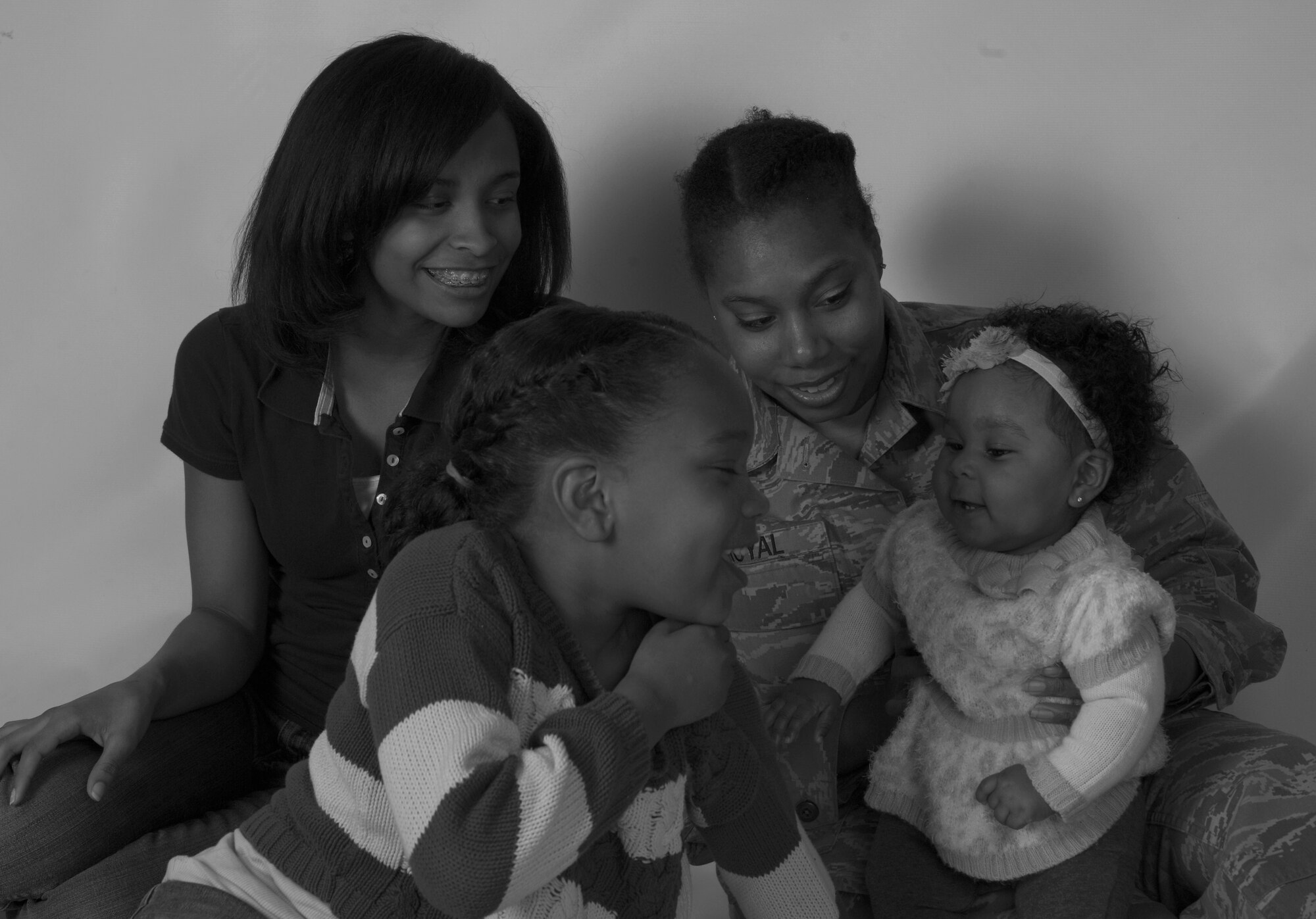 Staff Sgt. Shereka Royal, 48th Operations Support Squadron airfield management operations supervisor, poses with her daughters at Royal Air Force Lakenheath, England, April 30, 2015. Royal is the mother of three and has been in the U.S. Air Force for more than 12 years. (U.S. Air Force photo by Senior Airman Dawn M. Weber/Released)