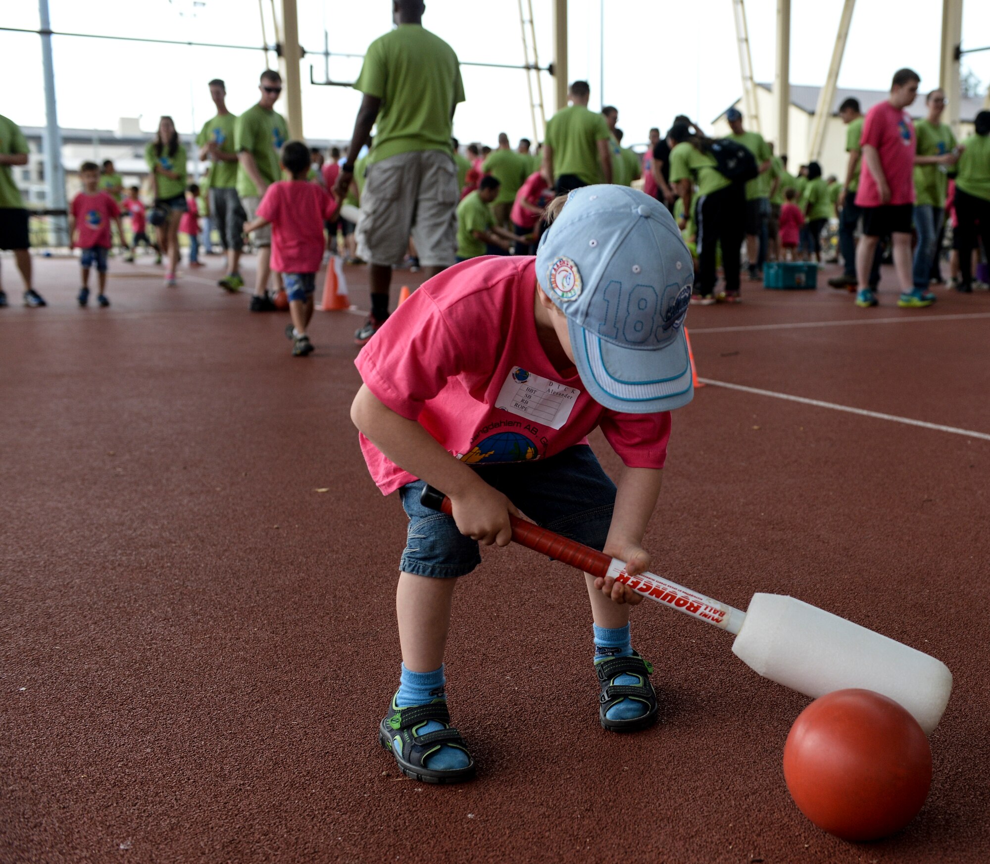 A child lines up his next shot in one of the games played during the St. Martin’s Special Children’s Day event July 22, 2015 at Spangdahlem Air Base, Germany. The event offers special needs children from local schools a chance to interact with the Saber Community. (US Air Force photo by Senior Airman Sarah Denewellis/Released)