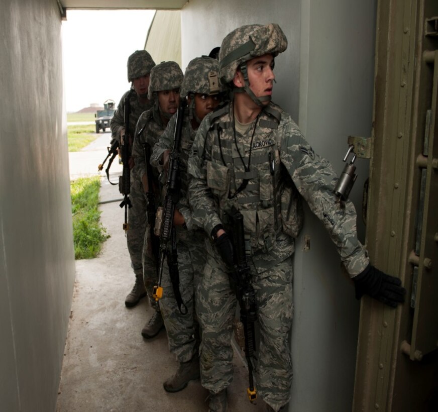 Airmen from the 39th Security Forces Squadron, prepare to tactically enter a protective aircraft shelter March 18, 2015, at Incirlik Air Base, Turkey.  The Airmen responded to a simulated attack from inside the shelter as part of an exercise to complete  one of their annual training requirements.  Security forces members  proactively train to ensure wartime readiness.  (U.S Air Force photo by Senior Airman  Krystal Ardrey/Released)
