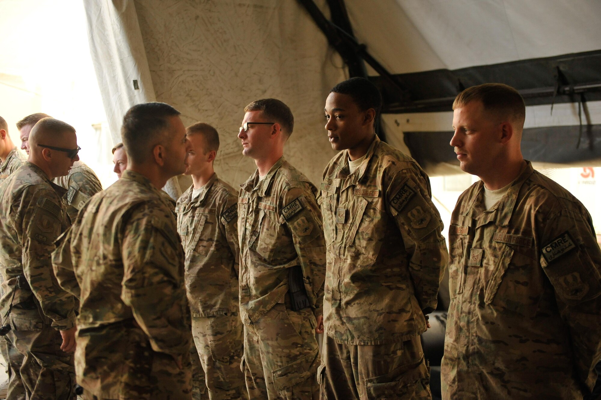 U.S. Air Force Brig. Gen. Dave Julazadeh, 455th Air Expeditionary Wing commander, and Chief Master Sgt. Matt Grengs, 455th AEW command chief talk with Airmen assigned to the 451st Air Expeditionary Group at Kandahar Airfield, July 25, 2015. The general and chief met with Airmen from across the group who provide intelligence, surveillance and reconnaissance for U.S. and Coalition forces operating outside the wire while also operating one of the busiest airfields in the theater.  (U.S. Air Force photo by Maj. Tony Wickman/Released)