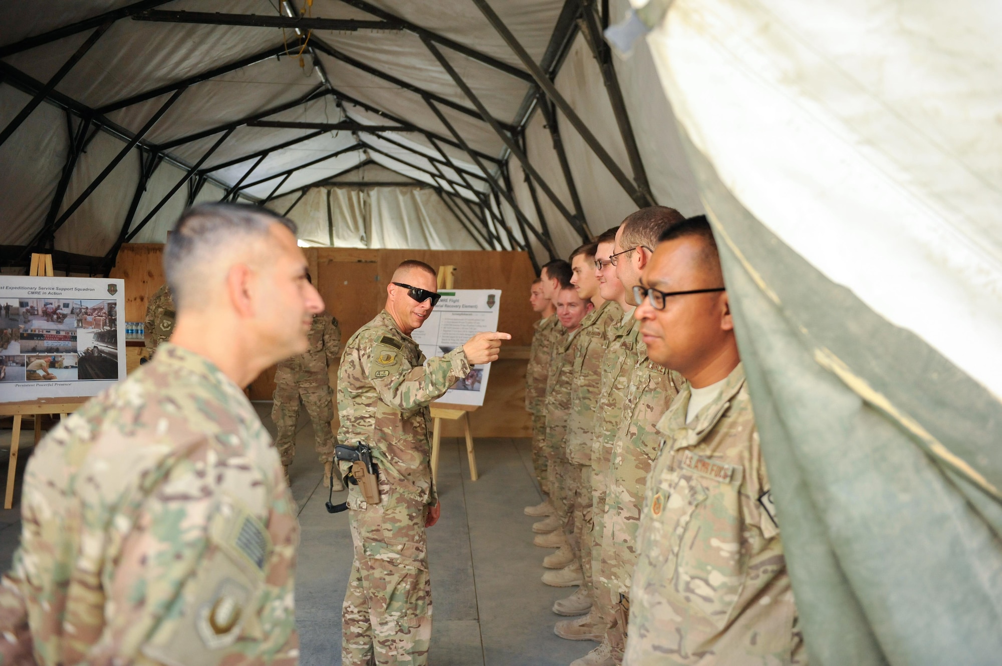 U.S. Air Force Brig. Gen. Dave Julazadeh, 455th Air Expeditionary Wing commander, and Chief Master Sgt. Matt Grengs, 455th AEW command chief talk with Airmen assigned to the 451st Air Expeditionary Group at Kandahar Airfield, July 25, 2015. The general and chief met with Airmen from across the group who provide intelligence, surveillance and reconnaissance for U.S. and Coalition forces operating outside the wire while also operating one of the busiest airfields in the theater.  (U.S. Air Force photo by Maj. Tony Wickman/Released)